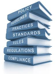 books stacked that are titled Policy, Guidelines, Practices, Standards, Rules, Regulations, and Compliance